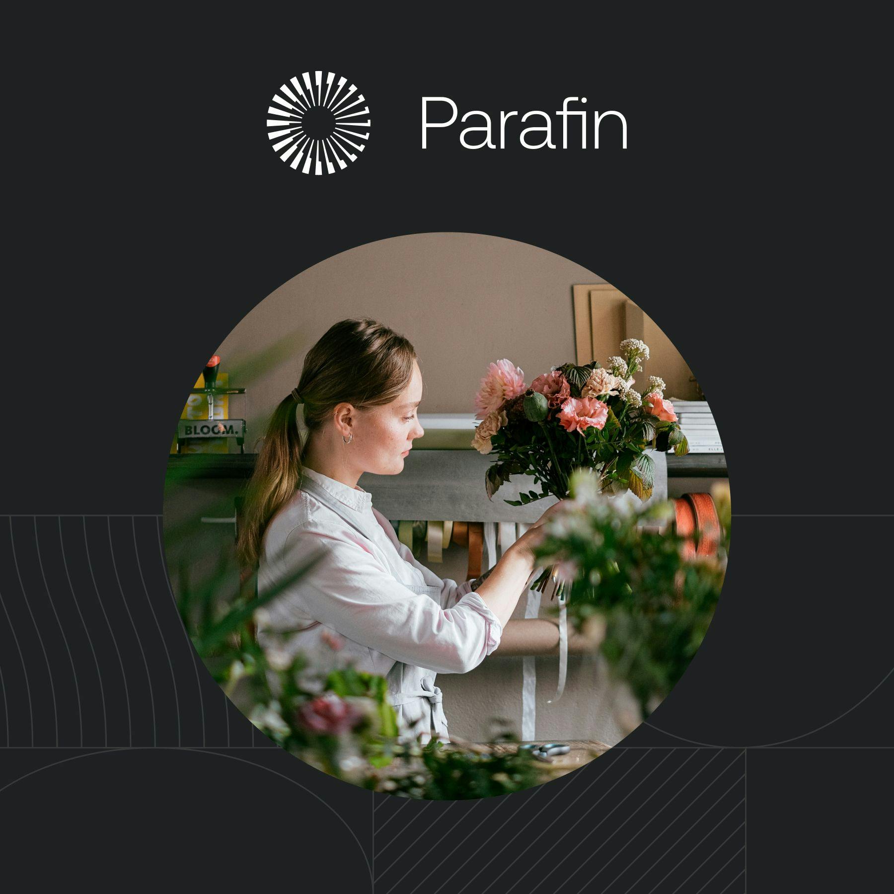 Photo of a woman building a flower arrangement with the Parafin logo superimposed