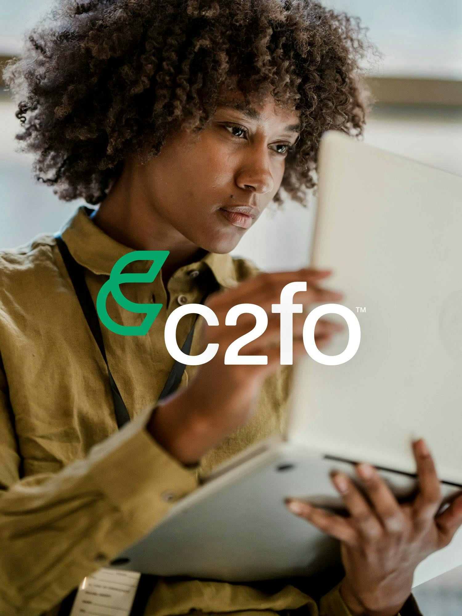 A business professional using a computer with the C2FO logo on top of the image